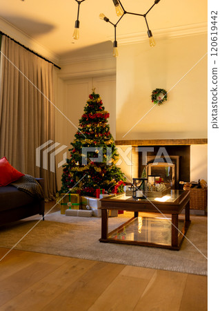 Decorated christmas tree by fireplace in homely living room, copy space 120619442