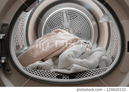Close up view drying machine with washed and dried towels in and door open. Close up view drying machine with washed and dried towels in and door open. 120620132