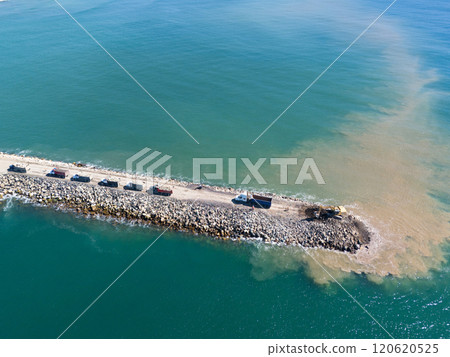 Trucks and excavator making work at sea Trucks and excavator making work at sea 120620525