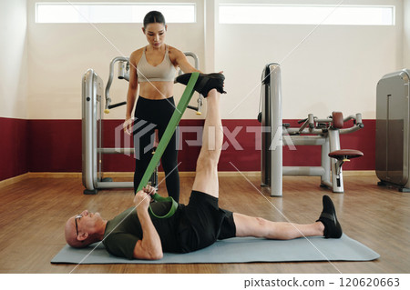 Assisting in Stretching Exercise with Resistance Band 120620663