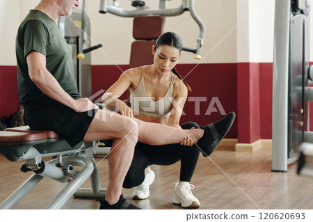 Helping Man During Physical Therapy Exercise Session Helping Man During Physical Therapy Exercise Session 120620693