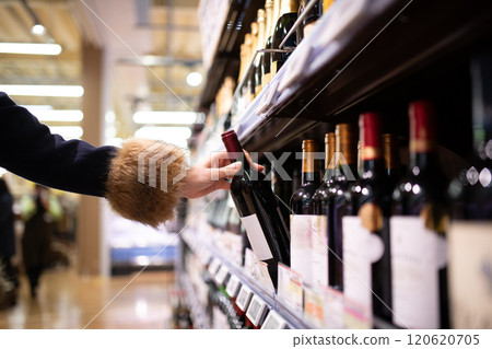 Woman's hand choosing wine 120620705