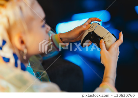 Gaming enthusiast enjoying a late-night session with a modern console Gaming enthusiast enjoying a late-night session with a modern console 120620760