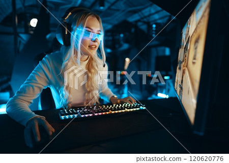 Young woman engaged in competitive gaming in a modern setup 120620776