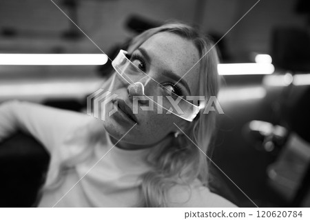 Portrait of a young woman with unique glasses in a stylish interior setting Portrait of a young woman with unique glasses in a stylish interior setting 120620784