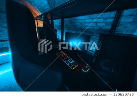 Modern gaming setup with vibrant lighting in a cozy underground room Modern gaming setup with vibrant lighting in a cozy underground room 120620786