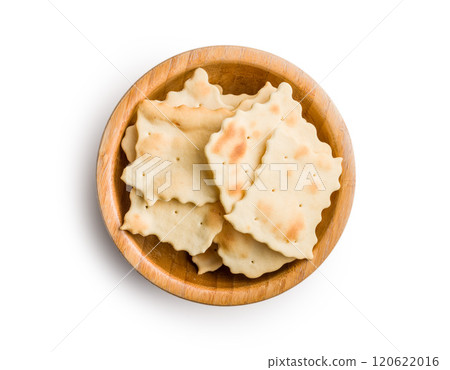 A crispy salted crackers in bowl isolated on white background. A crispy salted crackers in bowl isolated on white background. 120622016