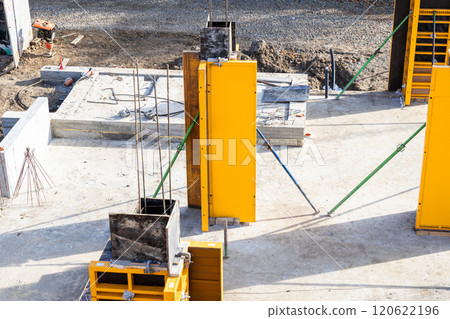 Construction site with concrete formwork and reinforcement rods for building foundation structures Construction site with concrete formwork and reinforcement rods for building foundation structures 120622196