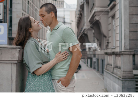 Happy couple of tourists walking embraced while sightseeing the town. Happy couple in front of palace of culture and science in Warsaw, Poland. Close up of a couple kissing. Happy couple of tourists walking embraced while sightseeing the town. Happy couple in front of palace of culture and science in Warsaw, Poland. Close up of a couple kissing. 120622293