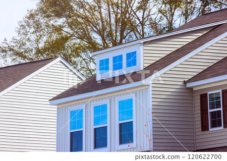 Residential building roof highlights modern windows amid suburban setting architecture features clean lines, neutral tones 120622700