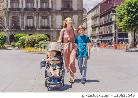 Mother, baby son and teenage son tourists in the central square of Mexico City, Zocalo. Family travel, cultural exploration, and historic architecture concept Mother, baby son and teenage son tourists in the central square of Mexico City, Zocalo. Family travel, cultural exploration, and historic architecture concept 120623549