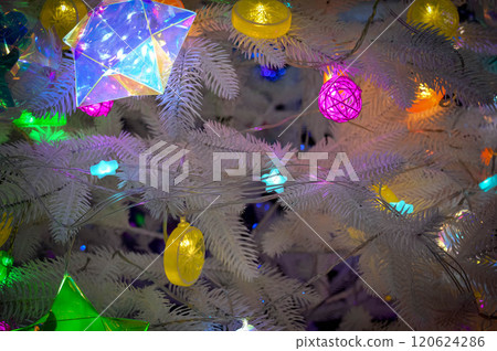 Christmas background with fluffy white Christmas tree and glowing garlands toys. High quality photo 120624286