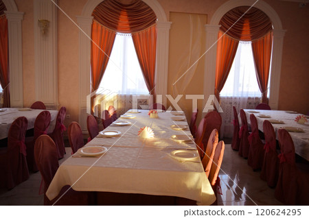 an empty hall is a classic restaurant with curtains white tablecloths and Romanesque decor. High quality photo 120624295
