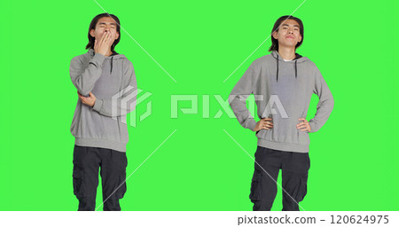 Male model feeling tired and yawning after not getting enough sleep, posing with fatigue over greenscreen template. Young asian person being extremely sleepy and exhausted, fall asleep. Male model feeling tired and yawning after not getting enough sleep, posing with fatigue over greenscreen template. Young asian person being extremely sleepy and exhausted, fall asleep. 120624975