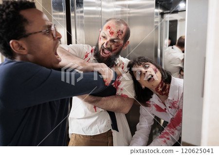 African american businessman struggling to escape from scary undead monsters coming out of elevator. Apocalypse survivor fighting with creepy evil zombies trying to devour his flesh in office building African american businessman struggling to escape from scary undead monsters coming out of elevator. Apocalypse survivor fighting with creepy evil zombies trying to devour his flesh in office building 120625041
