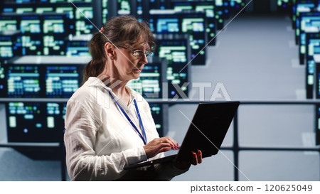 Data storage company executive working in workspace housing GPU dedicated servers that can process AI tasks with high efficiency, checking rigs used for machine learning showing drawbacks Data storage company executive working in workspace housing GPU dedicated servers that can process AI tasks with high efficiency, checking rigs used for machine learning showing drawbacks 120625049