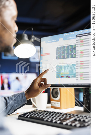 Analyst completing monthly income balance on computer, estimating expenses and investment in capital to boost earnings. Professional researcher investigates legal commerce figures and reports. 120625123