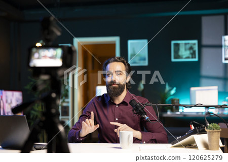 Interesting content creator hosting online show in neon lit studio, shooting vlog using professional camera. Vlogger presenting informations during streaming service broadcast filmed high tech gear Interesting content creator hosting online show in neon lit studio, shooting vlog using professional camera. Vlogger presenting informations during streaming service broadcast filmed high tech gear 120625279