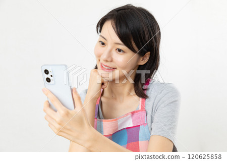 Housewife operating a smartphone 06 Housewife operating a smartphone 06 120625858