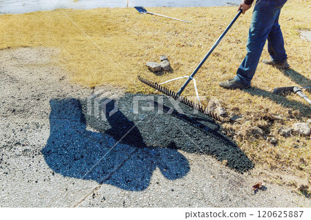 Potholes on road are repaired by asphalting damaged asphalt Potholes on road are repaired by asphalting damaged asphalt 120625887