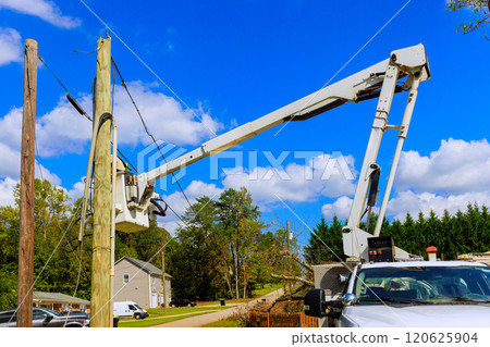 Severe hurricane has caused damage to electric pole power lines, which are being replaced Severe hurricane has caused damage to electric pole power lines, which are being replaced 120625904