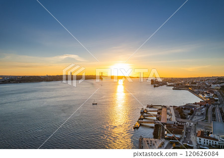 Sunset over the river with a bridge and shoreline in the background Sunset over the river with a bridge and shoreline in the background 120626084