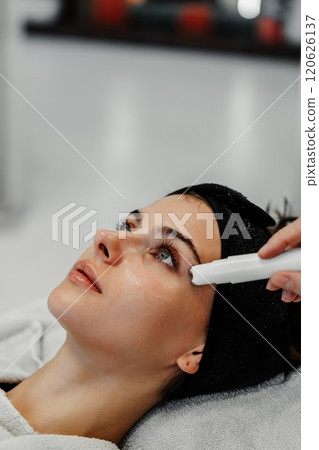 Woman receiving facial treatment in a modern spa environment during daytime Woman receiving facial treatment in a modern spa environment during daytime 120626137