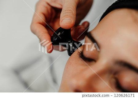 Facial treatment using a black massage tool for relaxation and rejuvenation 120626171