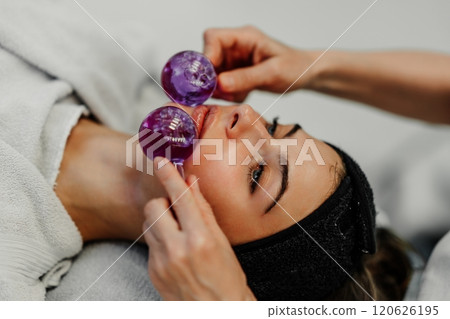 Facial treatment using glass globes for relaxation and skincare benefits Facial treatment using glass globes for relaxation and skincare benefits 120626195