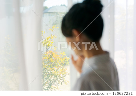 Woman opening curtain Woman opening curtain 120627281