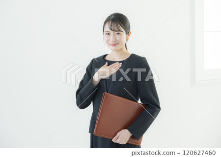 A woman in a black one-piece uniform 120627460