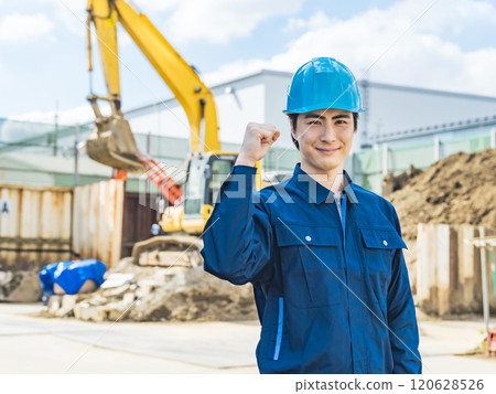 A male worker posing in front of a construction site 120628526