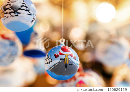 Christmas tree baubles hanging on christmas market stall, festive decorations 120629159
