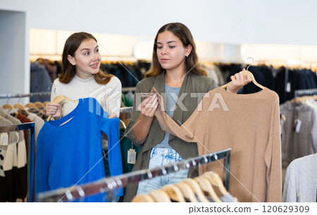 Woman with personal shopper shopping in store Woman with personal shopper shopping in store 120629309