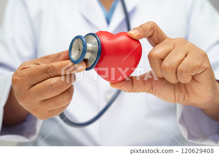 Doctor holding a red heart in hospital ward, healthy strong medical. Doctor holding a red heart in hospital ward, healthy strong medical. 120629408