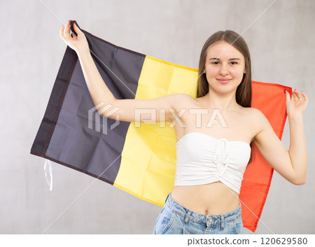 Young woman with Belgium flag posing in studio 120629580