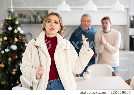 Two men quarreling with young woman 120629605