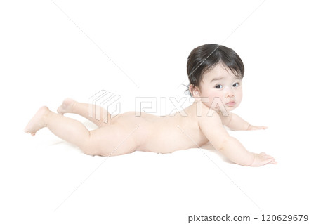 Full body side view of a crawling baby looking at the camera on a white background Full body side view of a crawling baby looking at the camera on a white background 120629679
