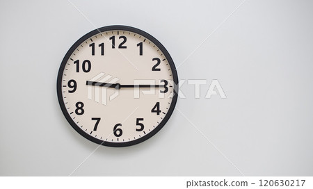 Classic Black-Edged Clock on White Background at 21.15/09.15 - Perfect for Time Management and Text Space Classic Black-Edged Clock on White Background at 21.15/09.15 - Perfect for Time Management and Text Space 120630217