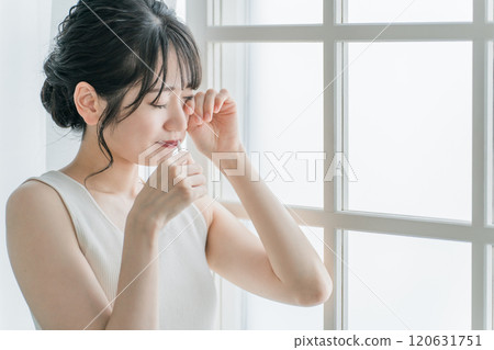 Young Asian woman crying because of toothache and pain Young Asian woman crying because of toothache and pain 120631751