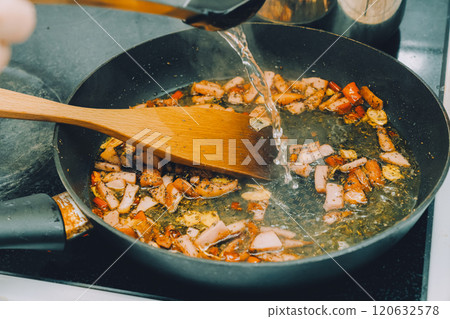 Frying pan cooking peperoncino 120632578