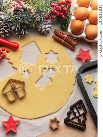 Baker is preparing christmas cookies using dough cutters and baking tray 120632833