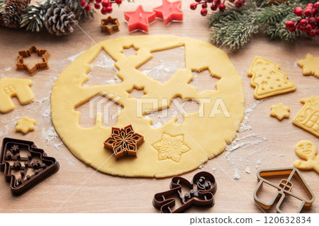 Christmas baking: preparing dough for festive cookies with various cookie cutters 120632834