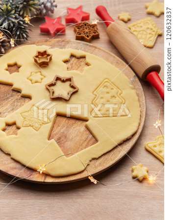 Preparing christmas cookies with dough, cutters, and festive decorations 120632837