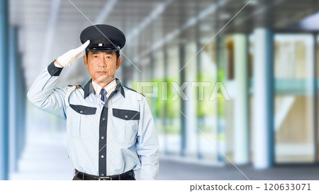 A male security guard saluting in the building's corridor 120633071