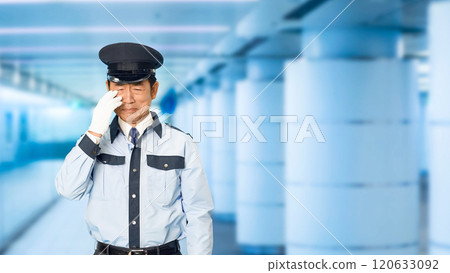 Male security guard crying in an underground passage 120633092