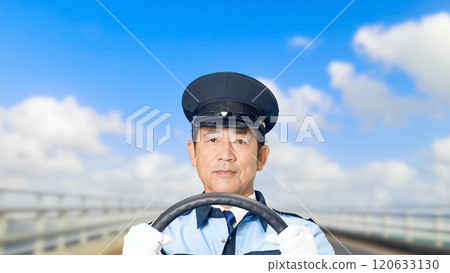A male driver holding the steering wheel and driving a car 120633130