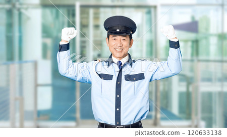 A male security guard pumping his fist at the building entrance 120633138
