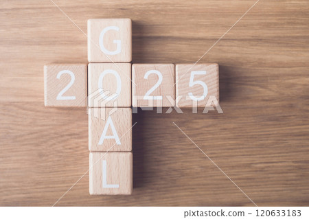 Wooden blocks spell out 'GOAL 2025' arranged on a table in a top-view perspective, symbolizing clear objectives and aspirations for the upcoming year. Focus and planning for future achievements Wooden blocks spell out 'GOAL 2025' arranged on a table in a top-view perspective, symbolizing clear objectives and aspirations for the upcoming year. Focus and planning for future achievements 120633183