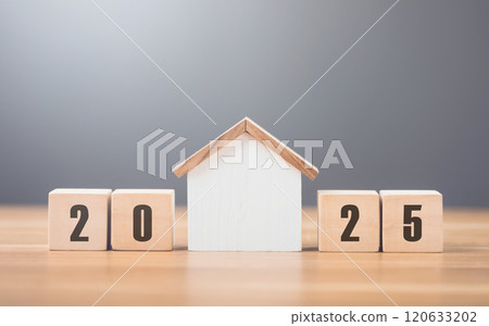2025 is write on a wooden block next to glass jar filled with coins and a house model, placed on a wooden table against a bright white. Financial planning, savings, and effective money management 2025 is write on a wooden block next to glass jar filled with coins and a house model, placed on a wooden table against a bright white. Financial planning, savings, and effective money management 120633202